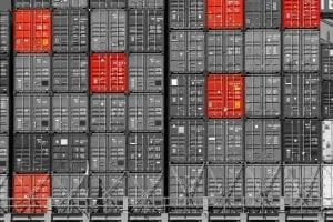 Stacked shipping container doors in gray and red.
